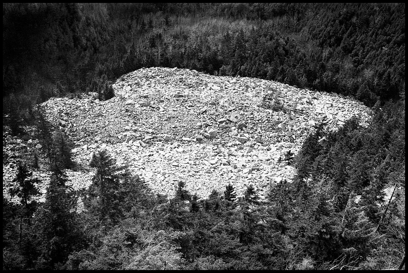 09a.jpg - Looking down at the Ice Beds, it seems like just a field of rock, but it is hard to get a sense of scale... many of those boulders are the size of automobiles and in many places the gaps between them are large enough for a person to climb down, out of sight, until you hit ice (rain and snow flows down into the spaces and freezes during the winter... the ice lasts all year 'round, hence the name).