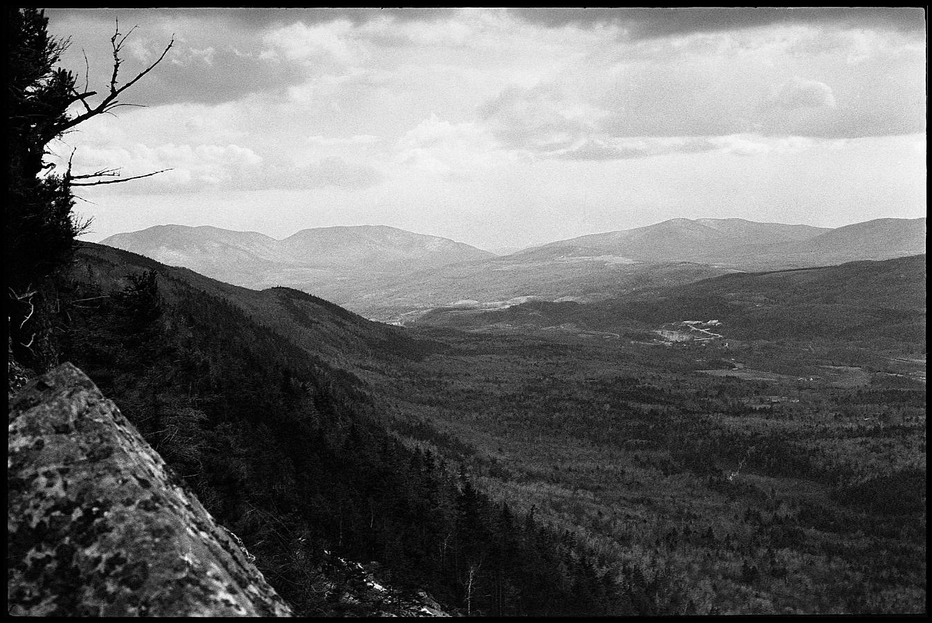 16a.jpg - It was still sunny to the south, but a dark band of clouds was covering us.  It had been a beautiful warm day when we left, so neither of us was dressed for a storm.  Fortunately, we didn't have to climb back down as there was a trail that went down the northeast side of the mountain.  Good thing too, by the time we got halfway down the trail it was snowing like hell and we were both freezing cold.  So ended my career as a mountainclimber.