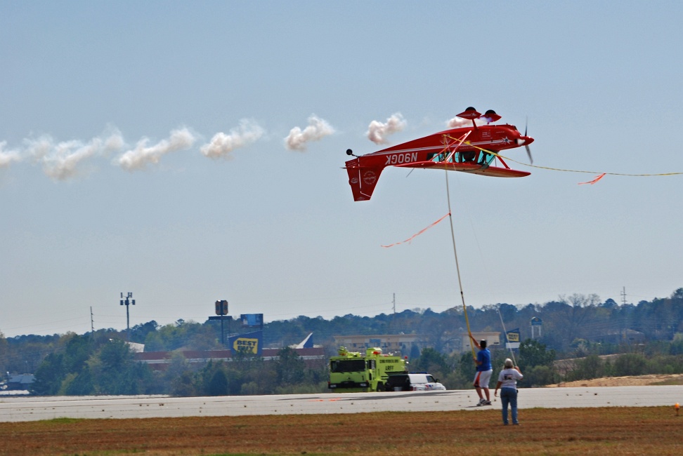 DSC_6785a.jpg - Greg prepares to snag a ribbon off of two poles using the tail of his airplane.